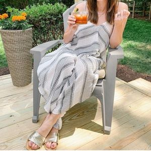 Wide leg spaghetti strap jumper with pockets and adjustable straps.